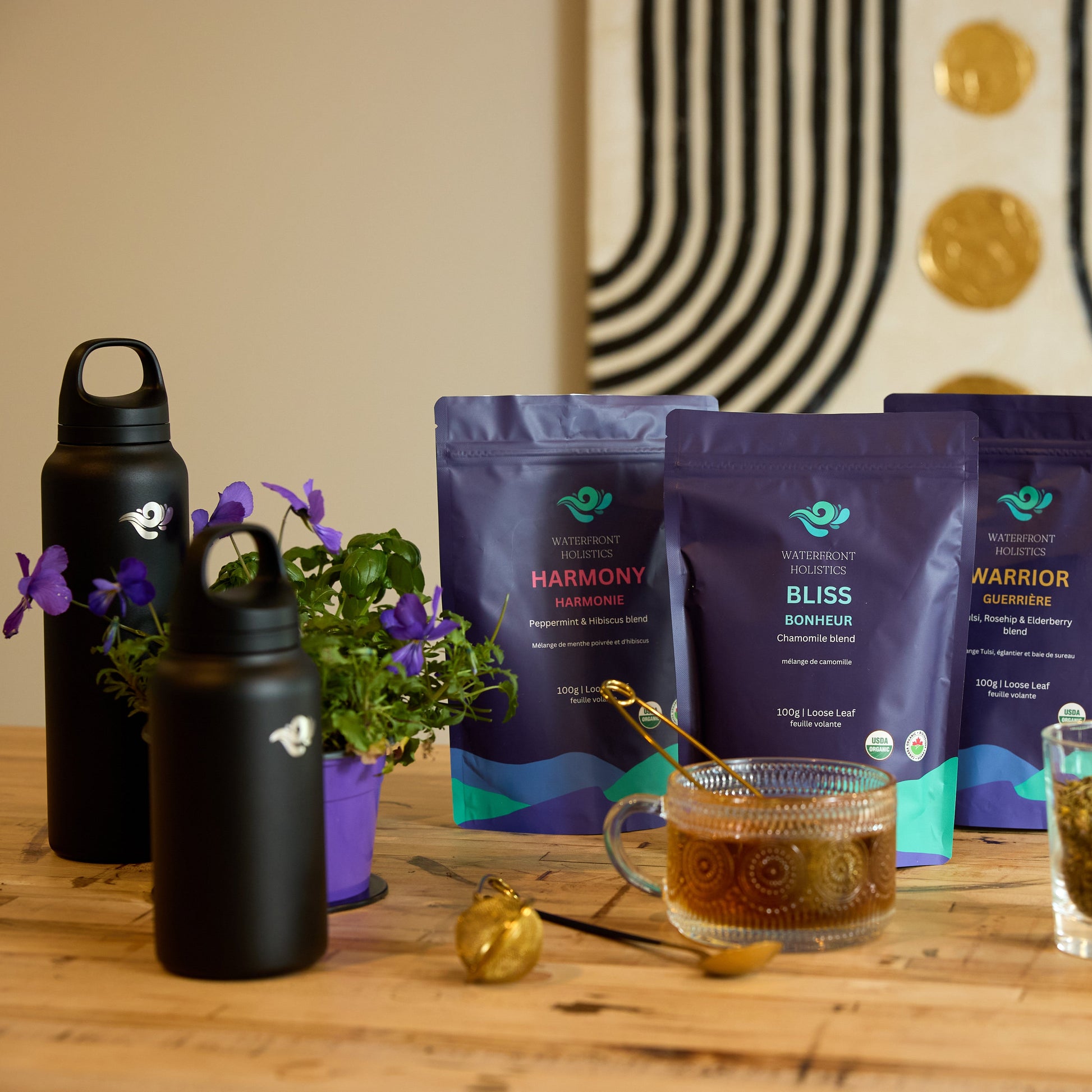 Tea packaging with a cup of tea and a glass of tea leaves on a wooden table.